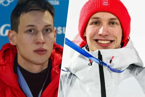 Kacper Tomasiak, sportowiec, którego wzrost budzi podziw, w czerwonej kurtce i czapce z olimpijskim logo.
