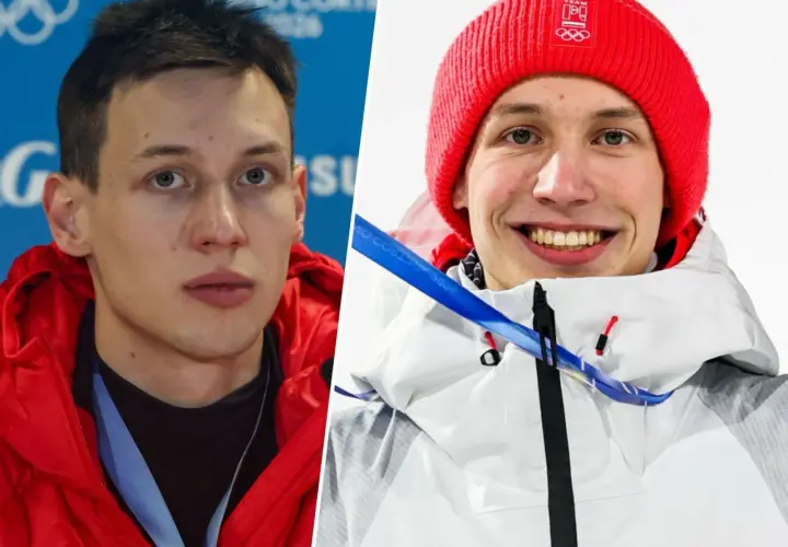 Kacper Tomasiak, sportowiec, którego wzrost budzi podziw, w czerwonej kurtce i czapce z olimpijskim logo.