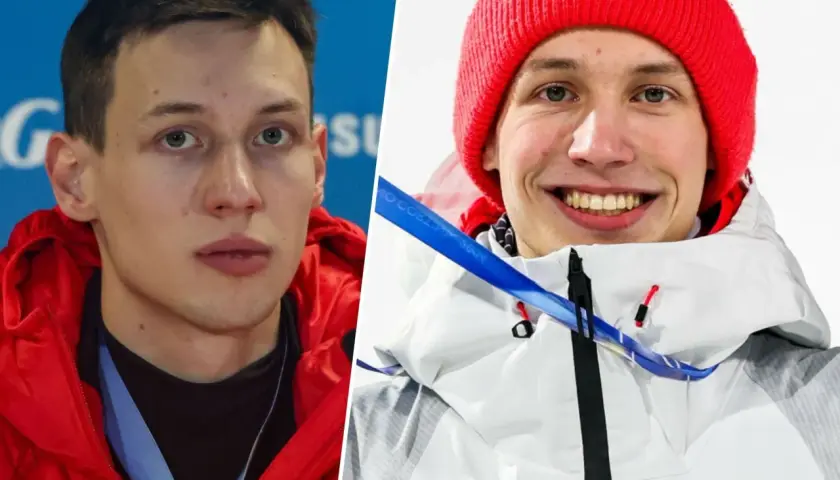 Kacper Tomasiak, sportowiec, którego wzrost budzi podziw, w czerwonej kurtce i czapce z olimpijskim logo.