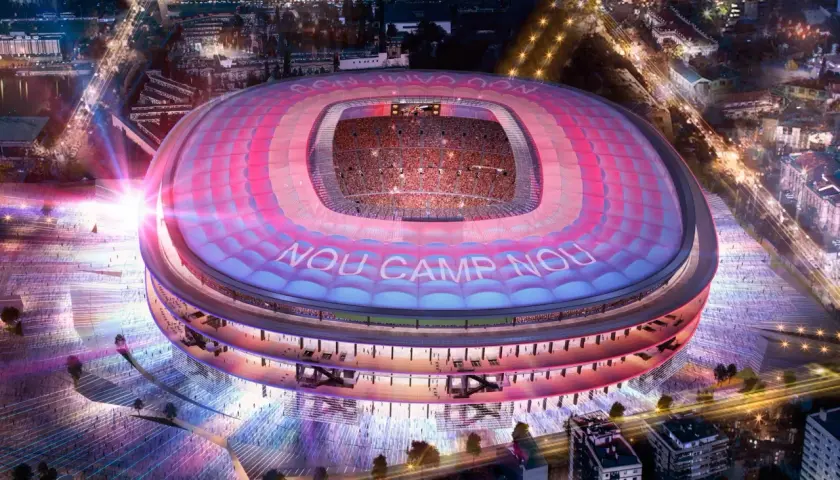 Nowy Camp Nou nocą, oświetlony różowo-niebieskimi światłami, z widocznymi trybunami i napisem "NOU CAMP NOU".
